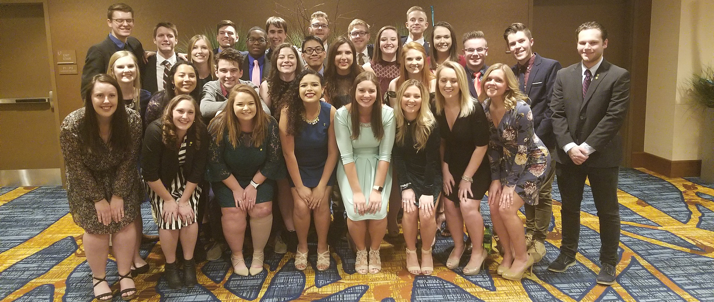 Picture of Fraternity and Sorority in graduation gowns posing