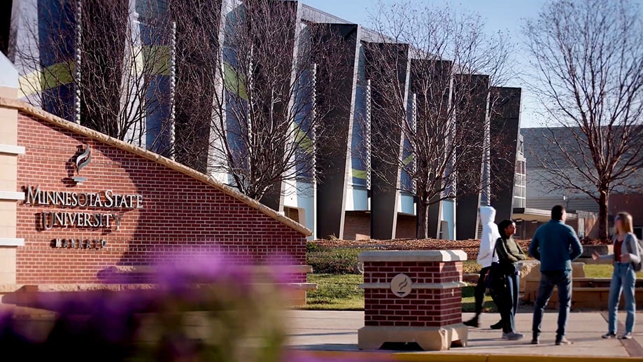 a group of people walking in front of a building