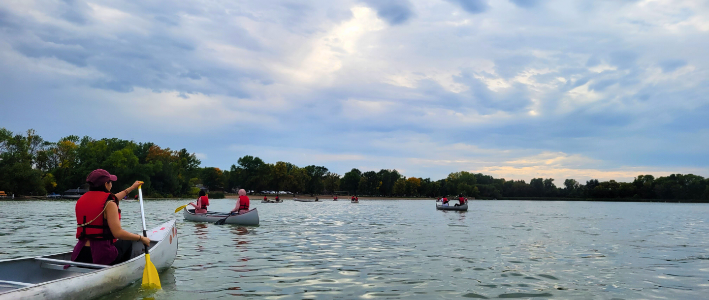 people canoes on a lake