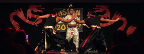 Three international students dancing at the CELP cultural event