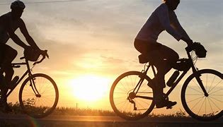 a couple of people riding bicycles