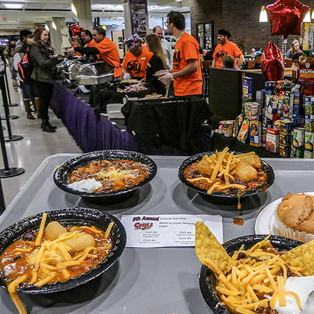 a group of people in a room with food