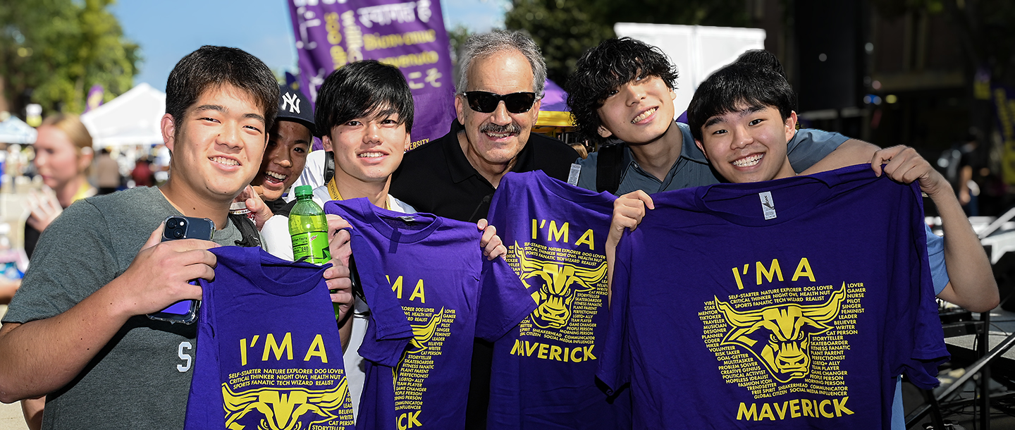 a group of people holding up shirts