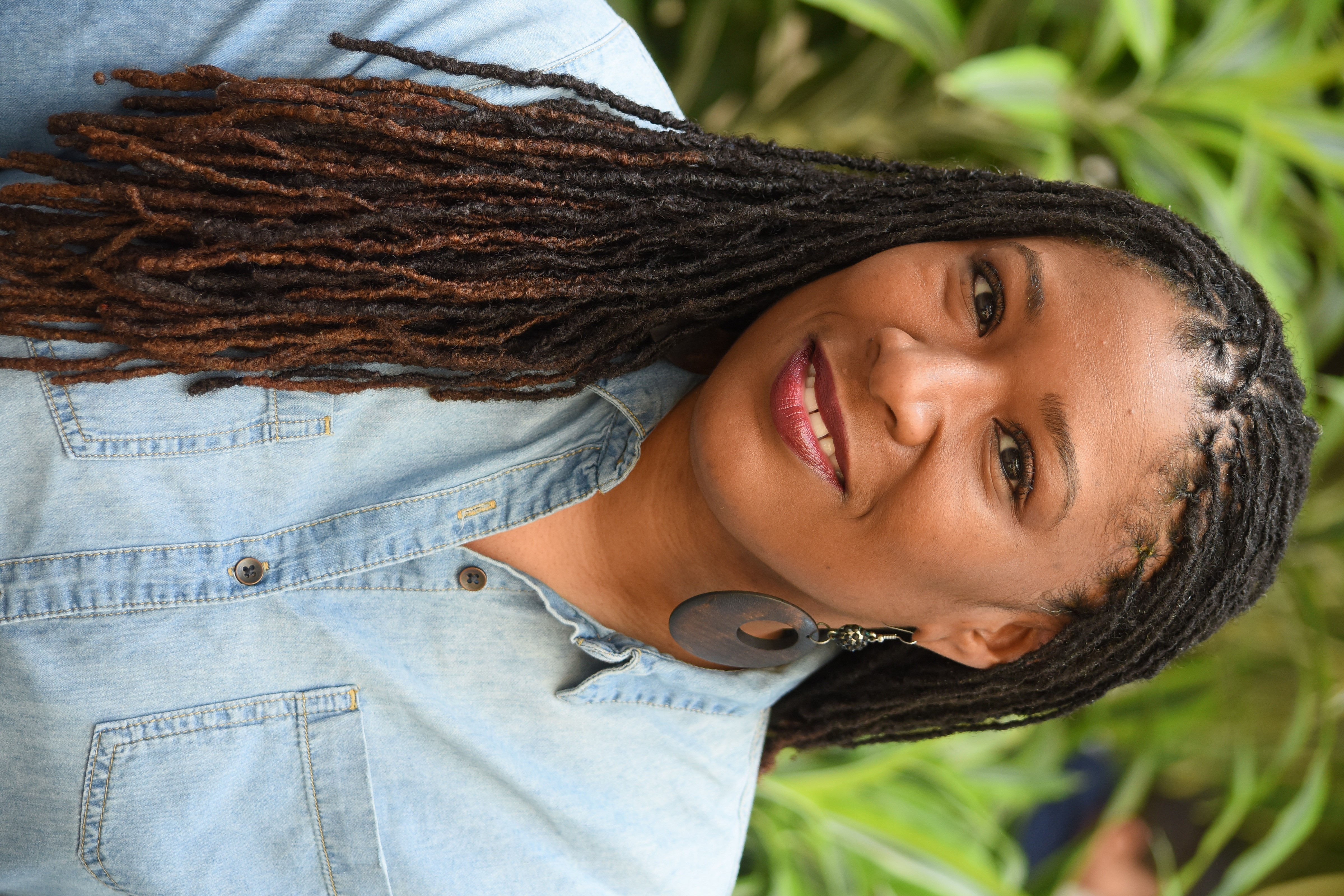 a person with long braids smiling