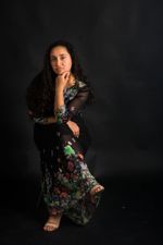 Ana Leyva sitting on a chair posing for a professional photo