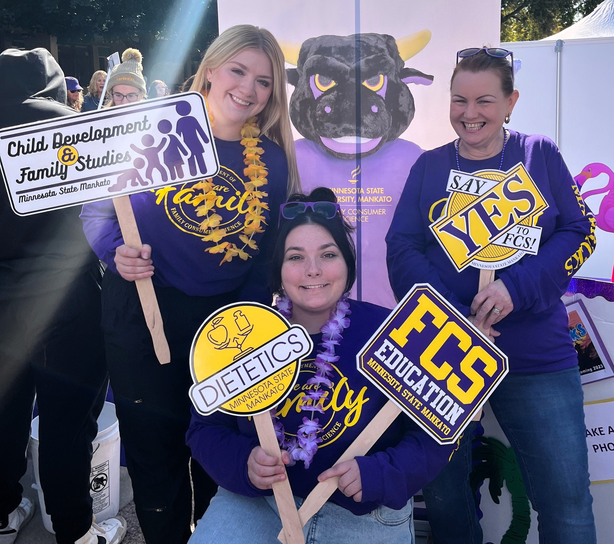 a group of women holding signs