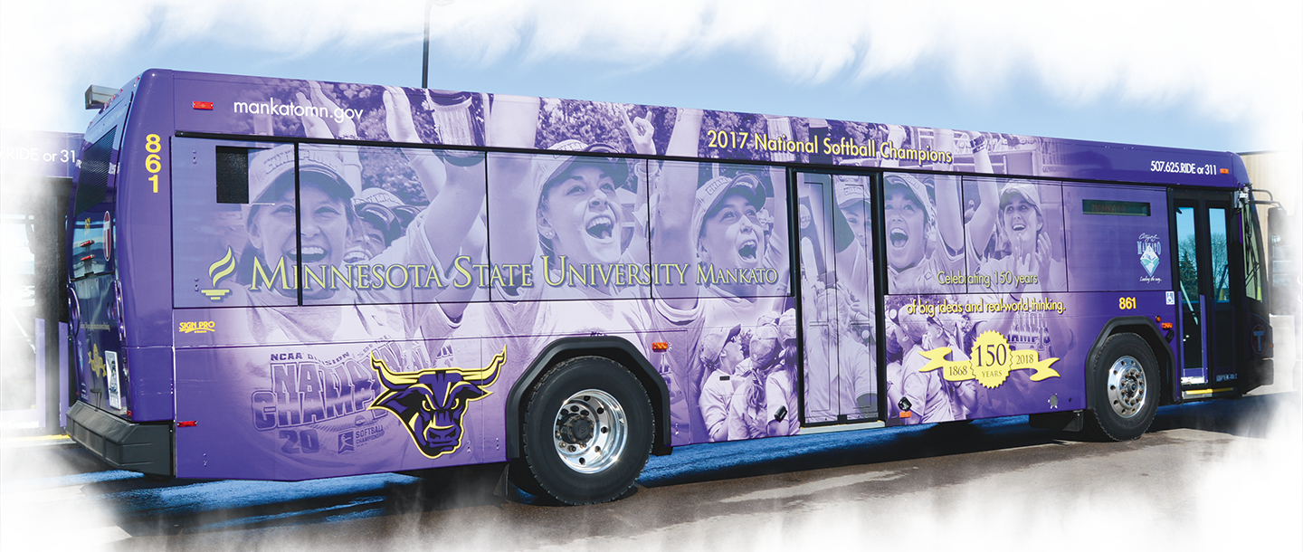 City of Mankato bus with the Minnesota State Mankato logo wrap featuring an image of the 2017 women's softball team national champions