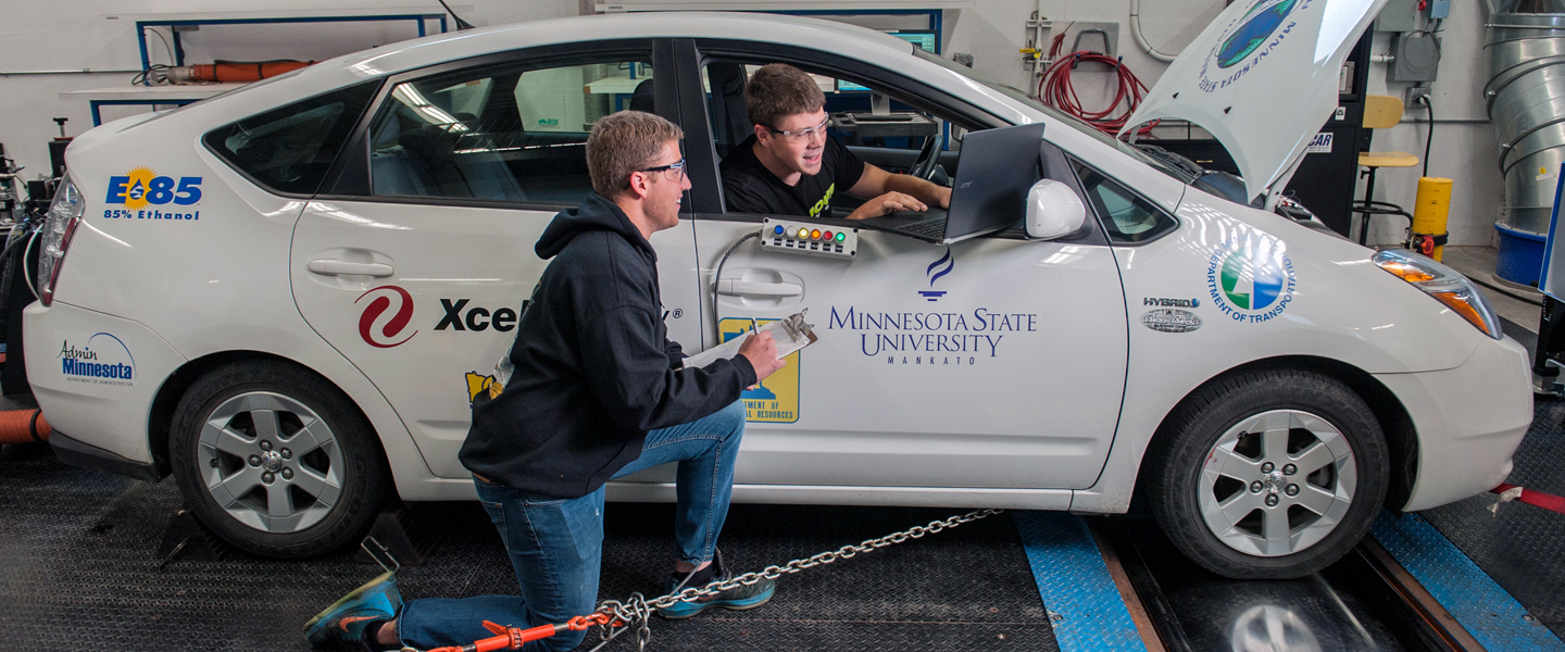 Two students working together on a car motor project