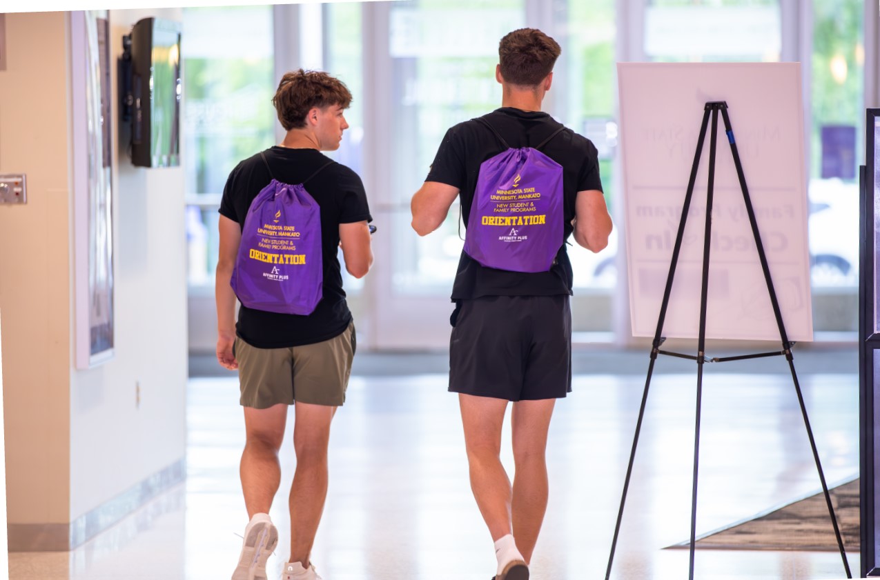 two men walking in a hallway