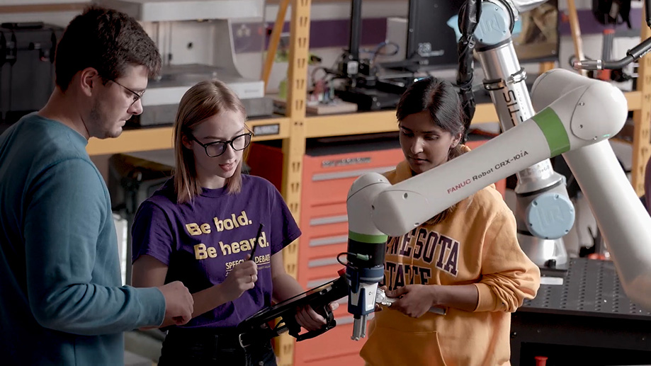 a group of people looking at a machine