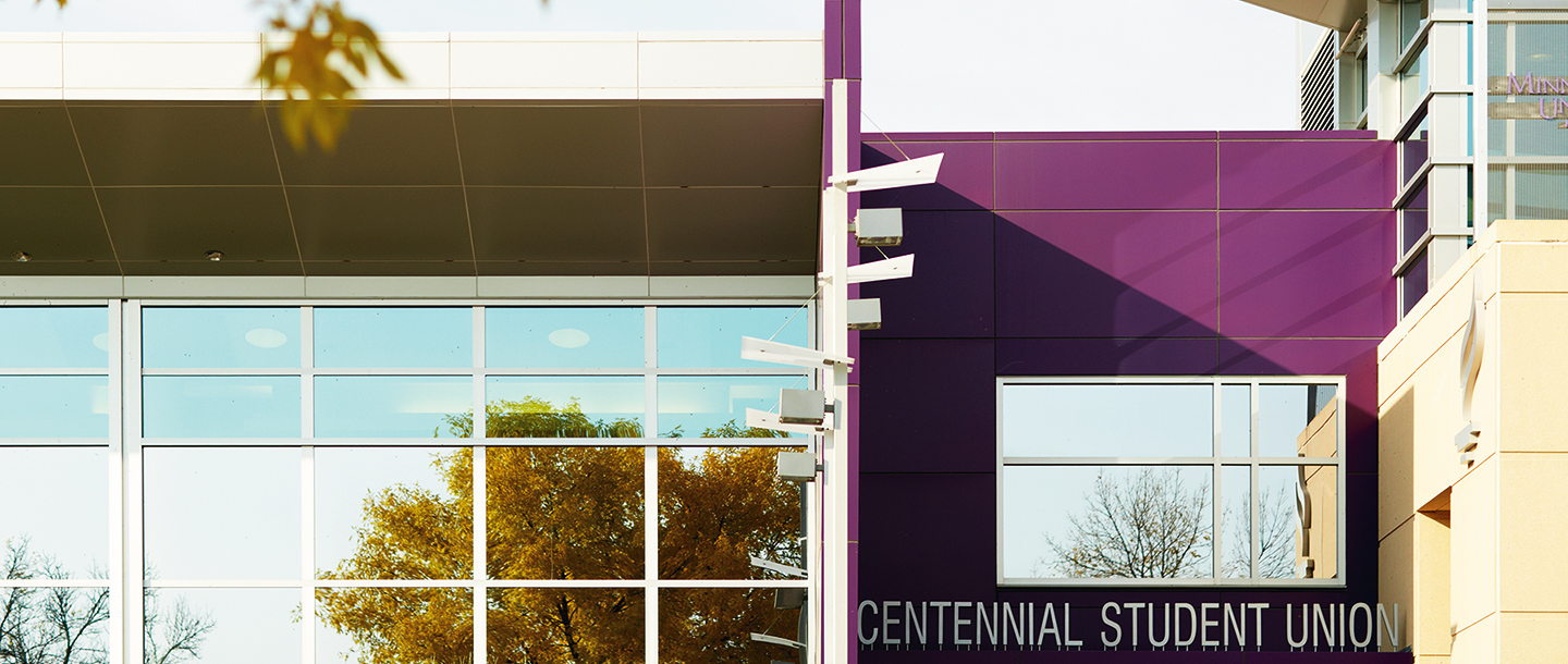 Reflection of trees in the windows outside of the Centennial Student Union