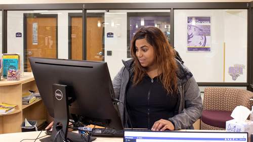 Student looking at a computer in the Career Development Center