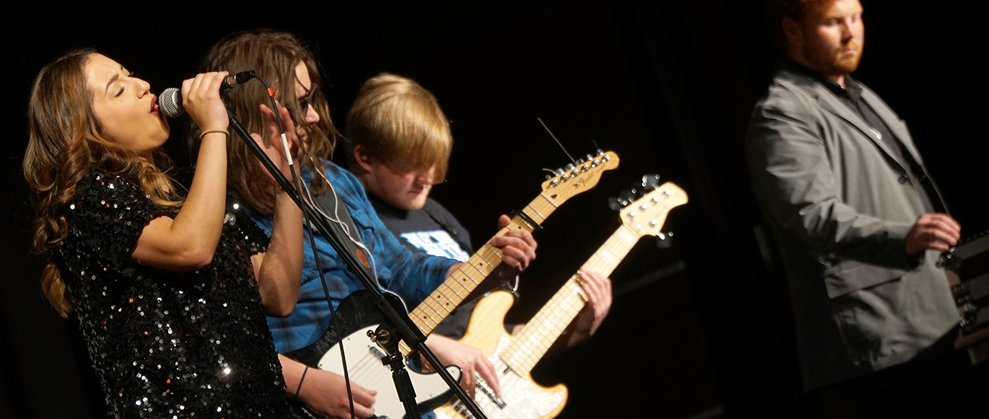 a couple of people playing guitars