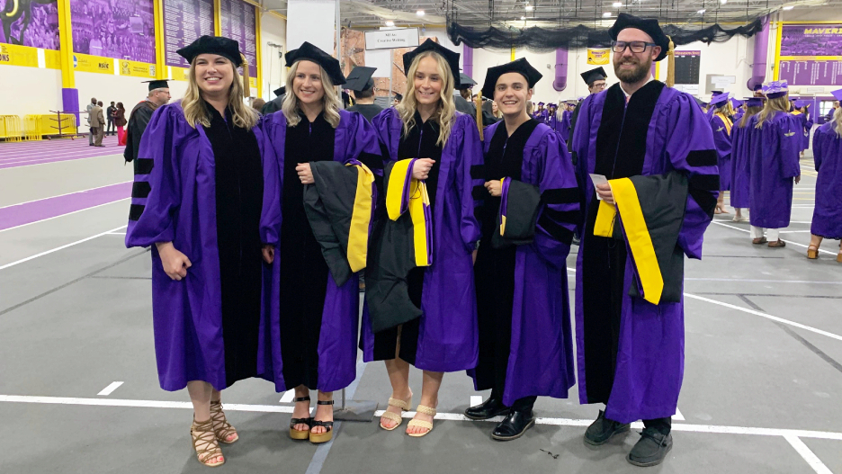 a group of people wearing graduation gowns and caps