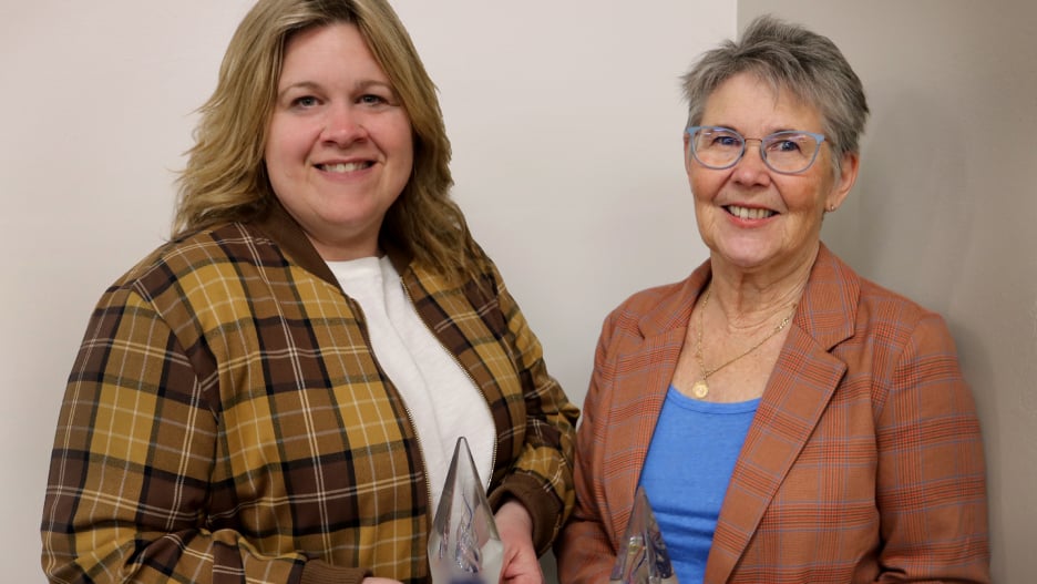 two women smiling at the camera