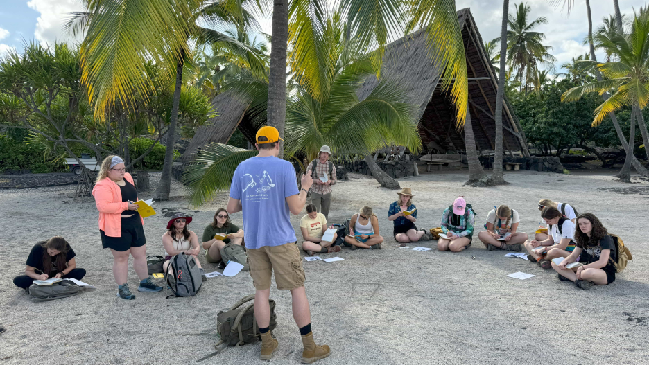 a group of people sitting on the ground