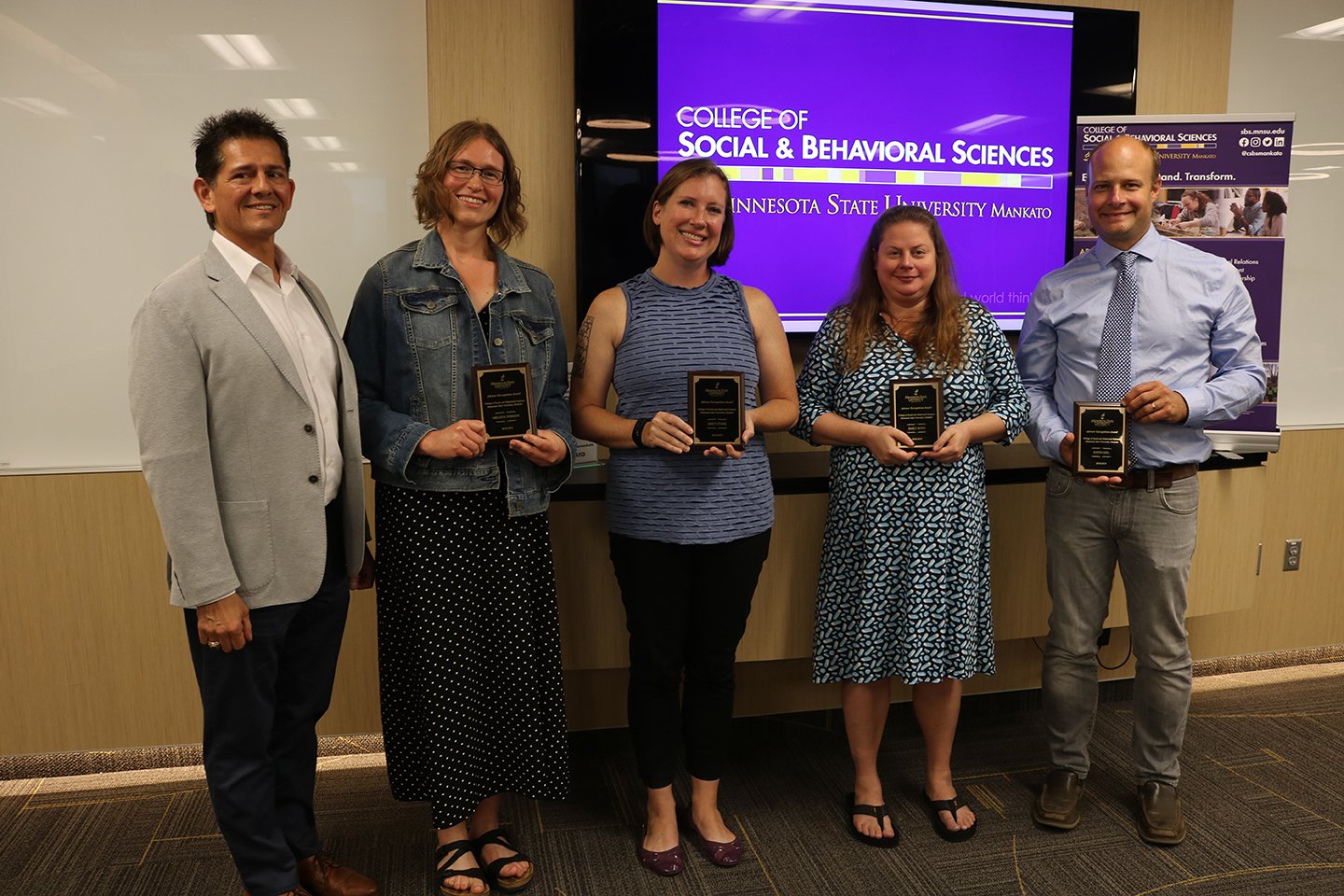 a group of people holding awards