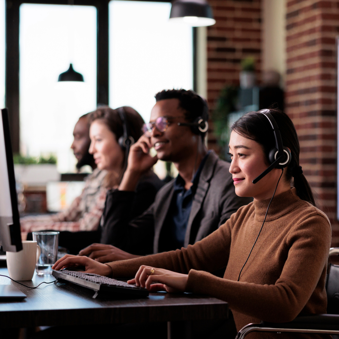 a group of people sitting at a desk