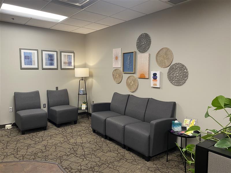 A waiting room with couches and chairs