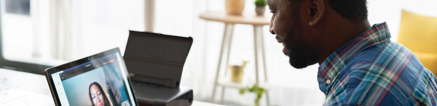 Staff member taking a video call on a laptop