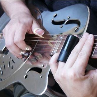 An individual playing the steel guitar