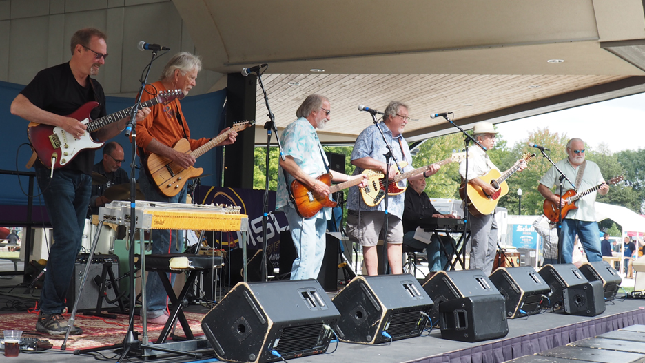 a group of people playing instruments on a stage