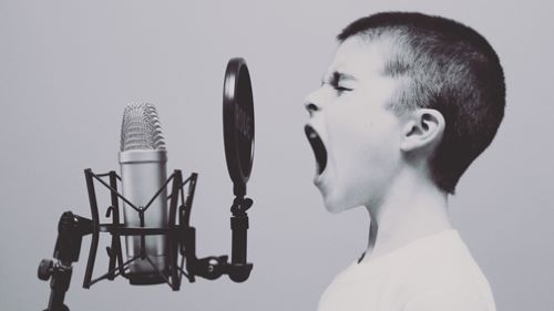 Child singing in front of a microphone