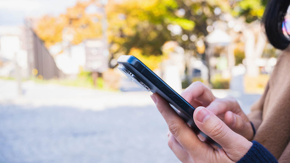 view of female student using the mobile phone to enter information