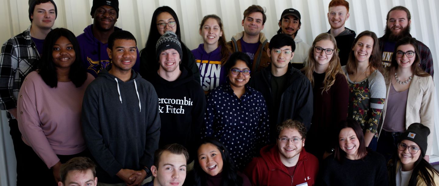 Students posing in the hallway with smiles