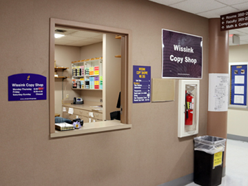 a room with a window and a sign