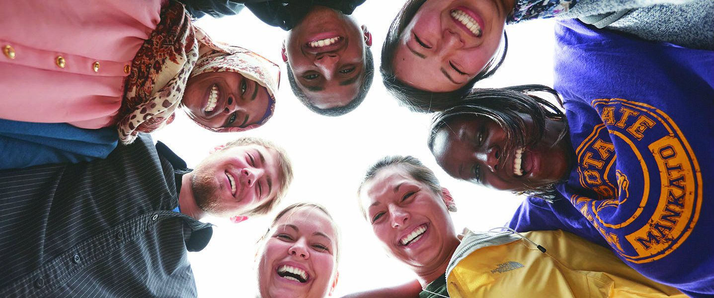 group of students hudeling