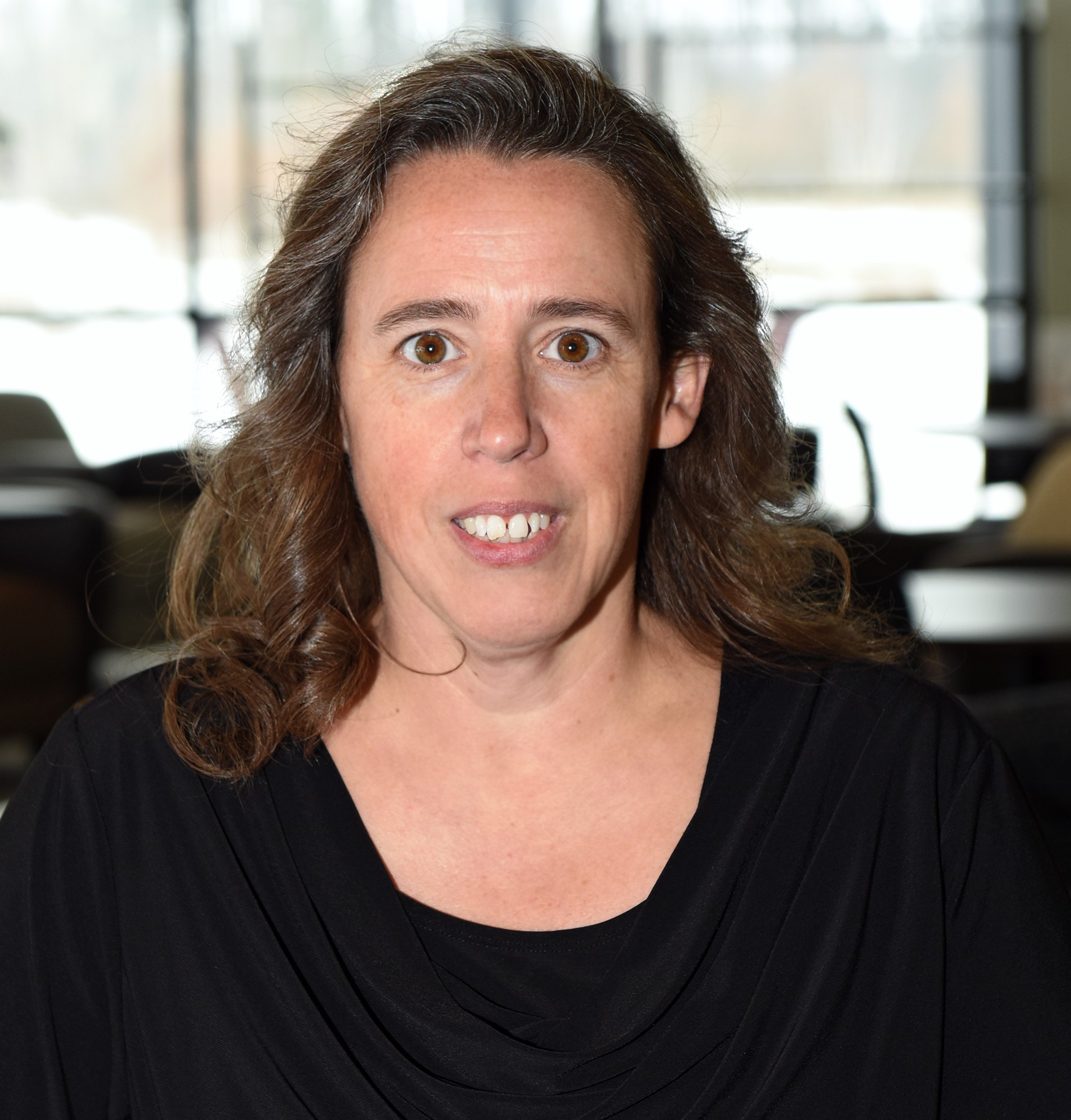 a person with brown hair wearing a black shirt