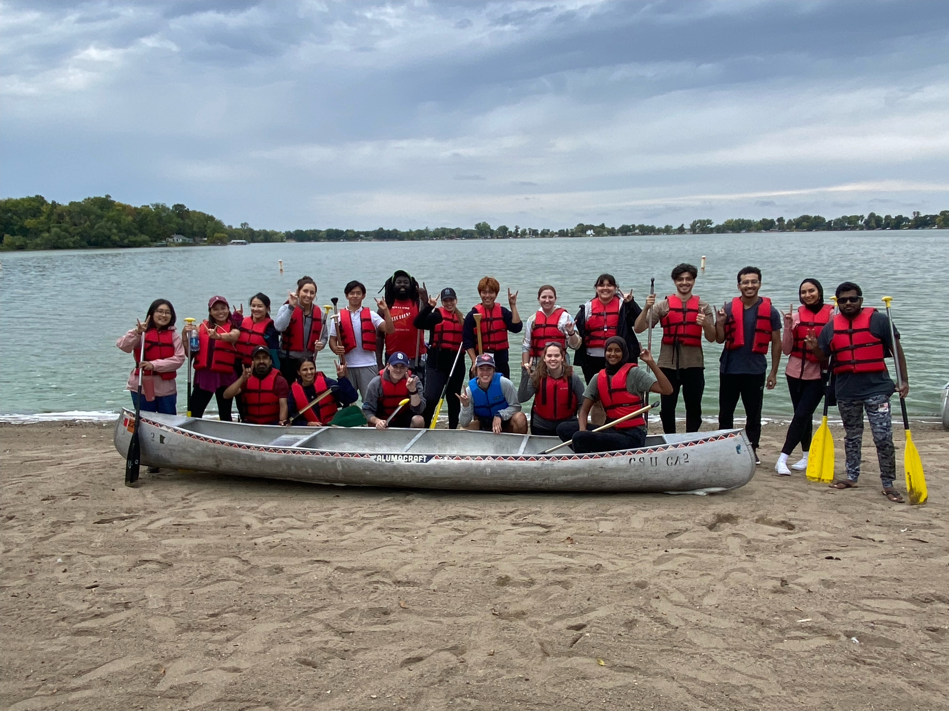 a group of people in life vests posing for a photo