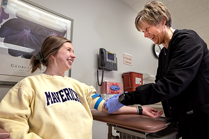 student with lab worker