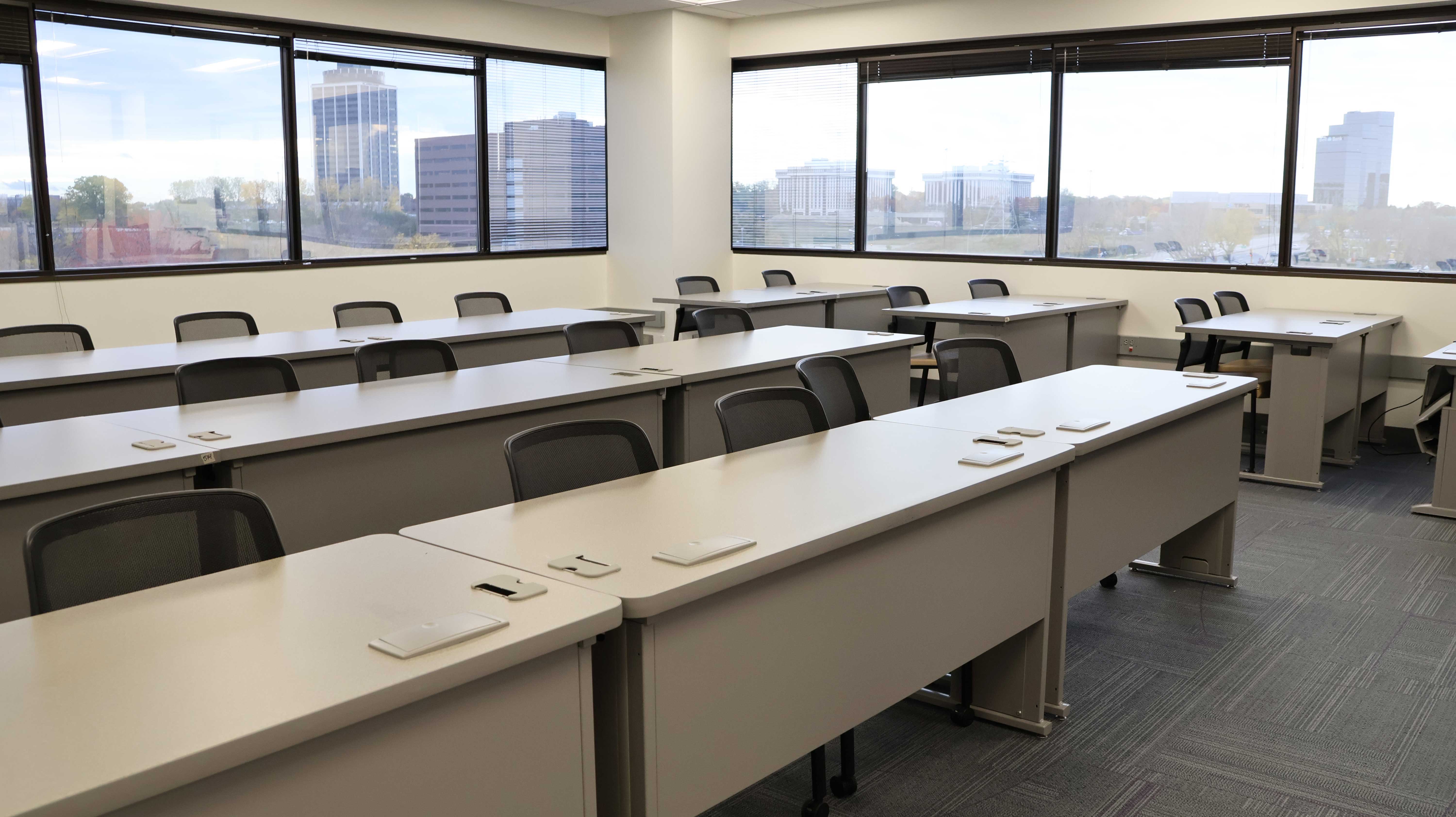 a room with white tables and chairs