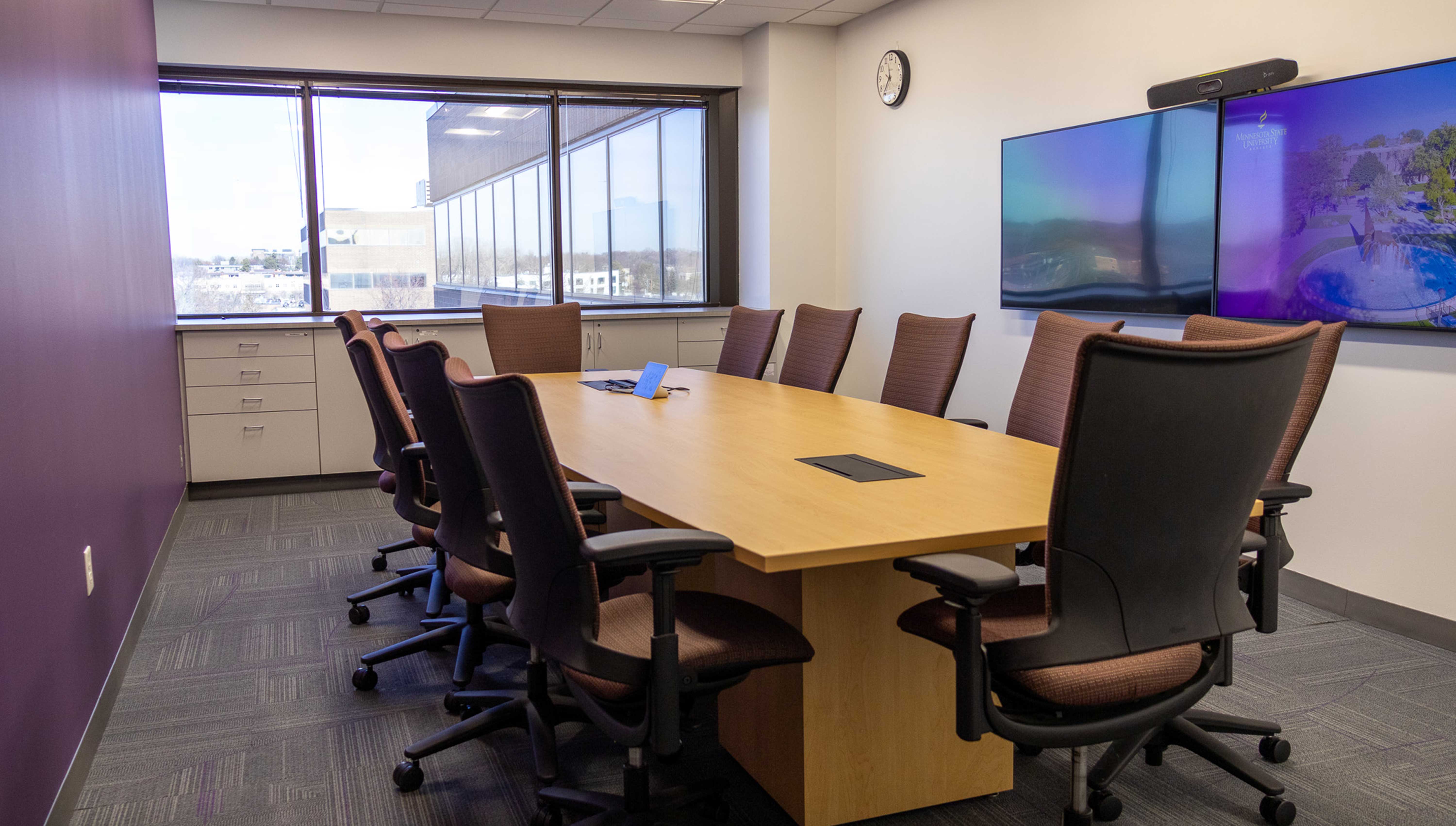 a conference room with a table and chairs