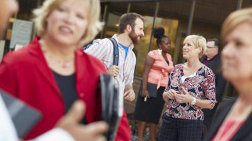 a group of people having discussion outside on campus