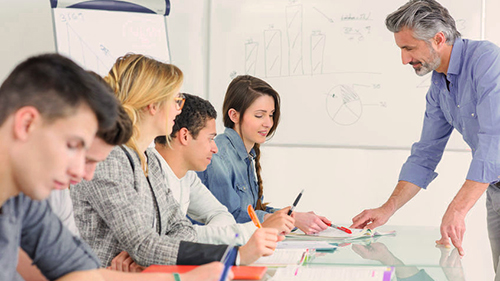 teacher and students in a classroom having a discussion