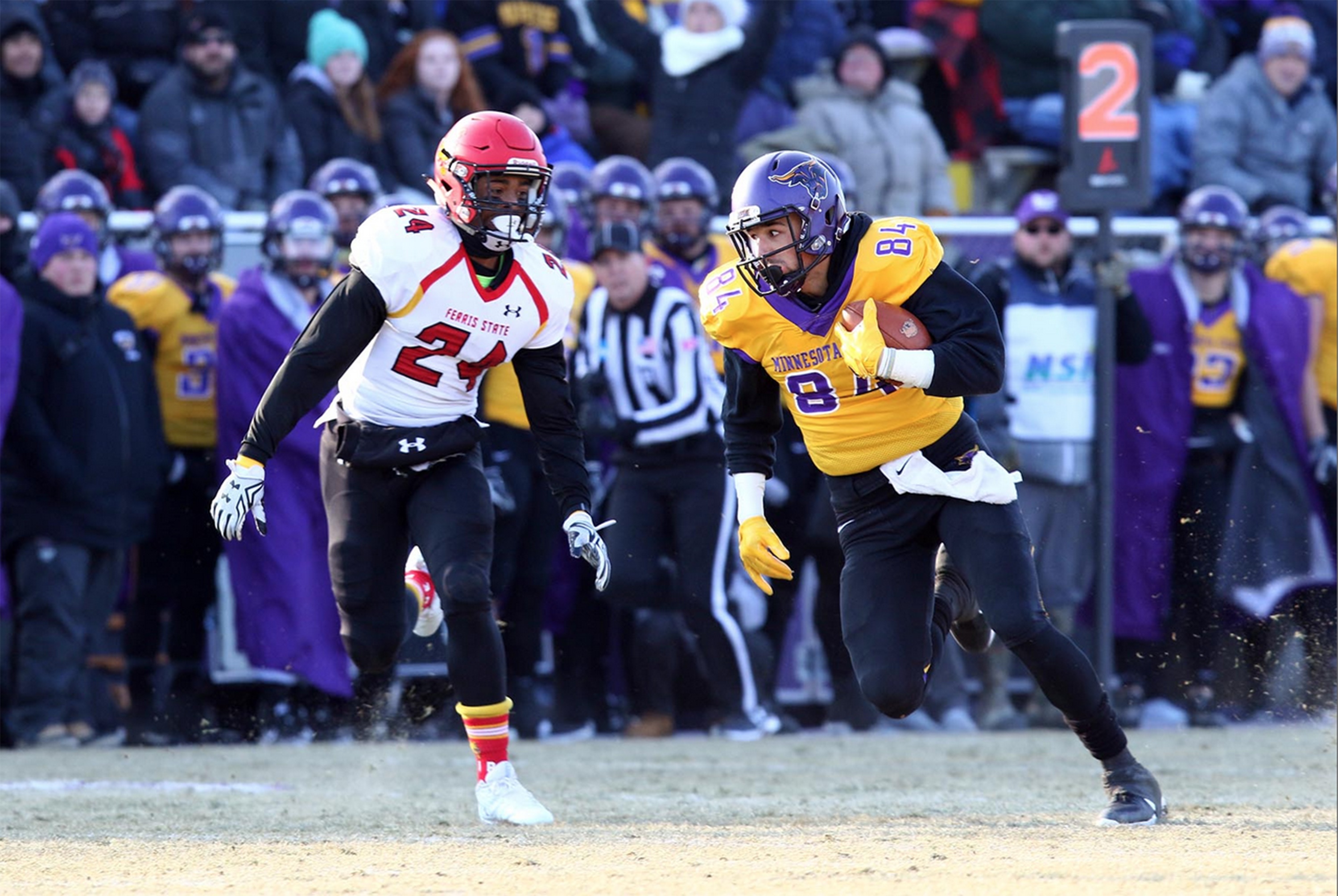 a football player running with a football in the air