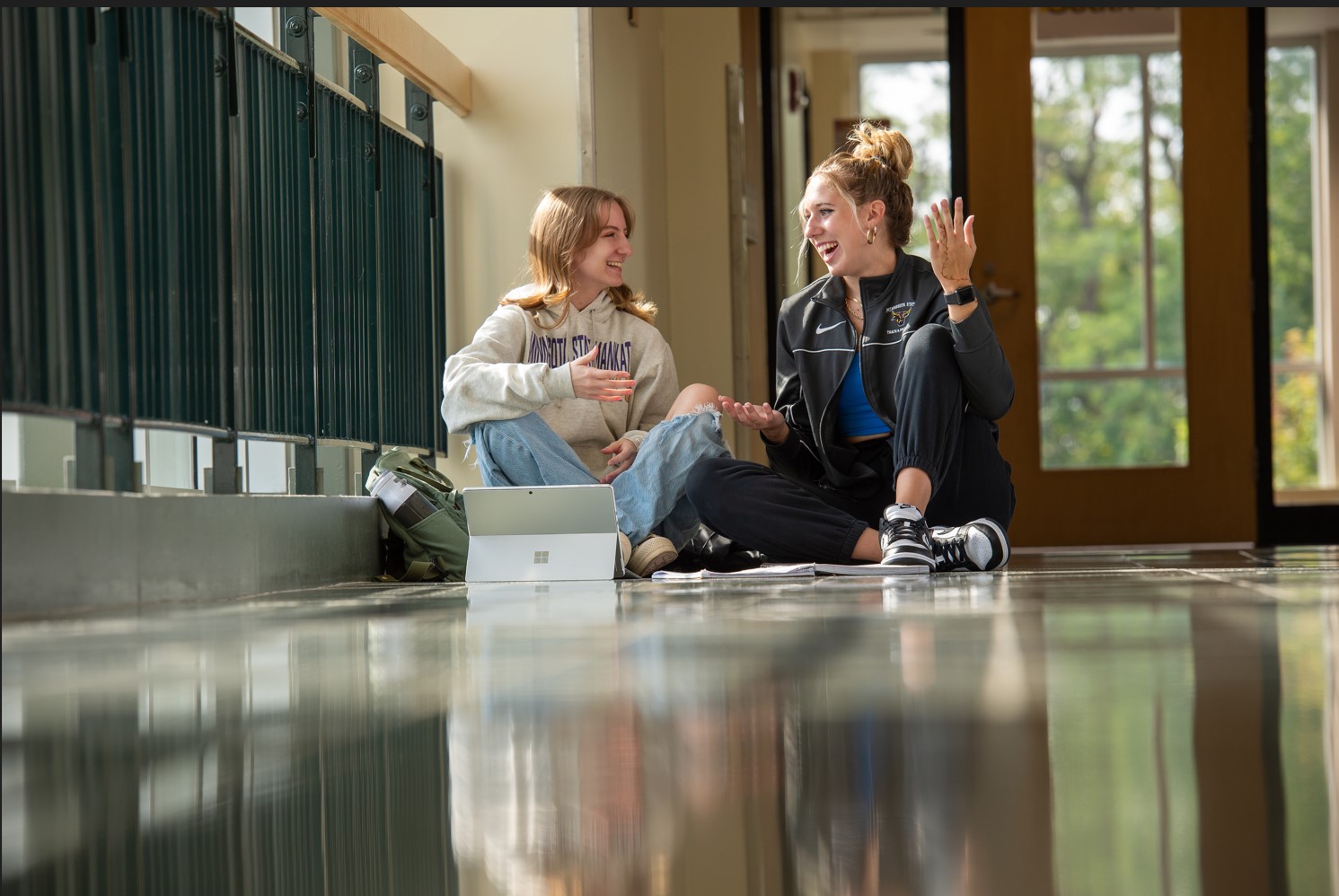 Students sitting in the hallway and having a chat