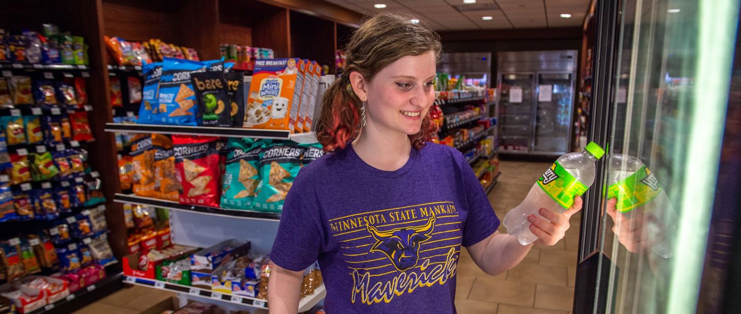 A student looking for some snacks in the convenience store on campus