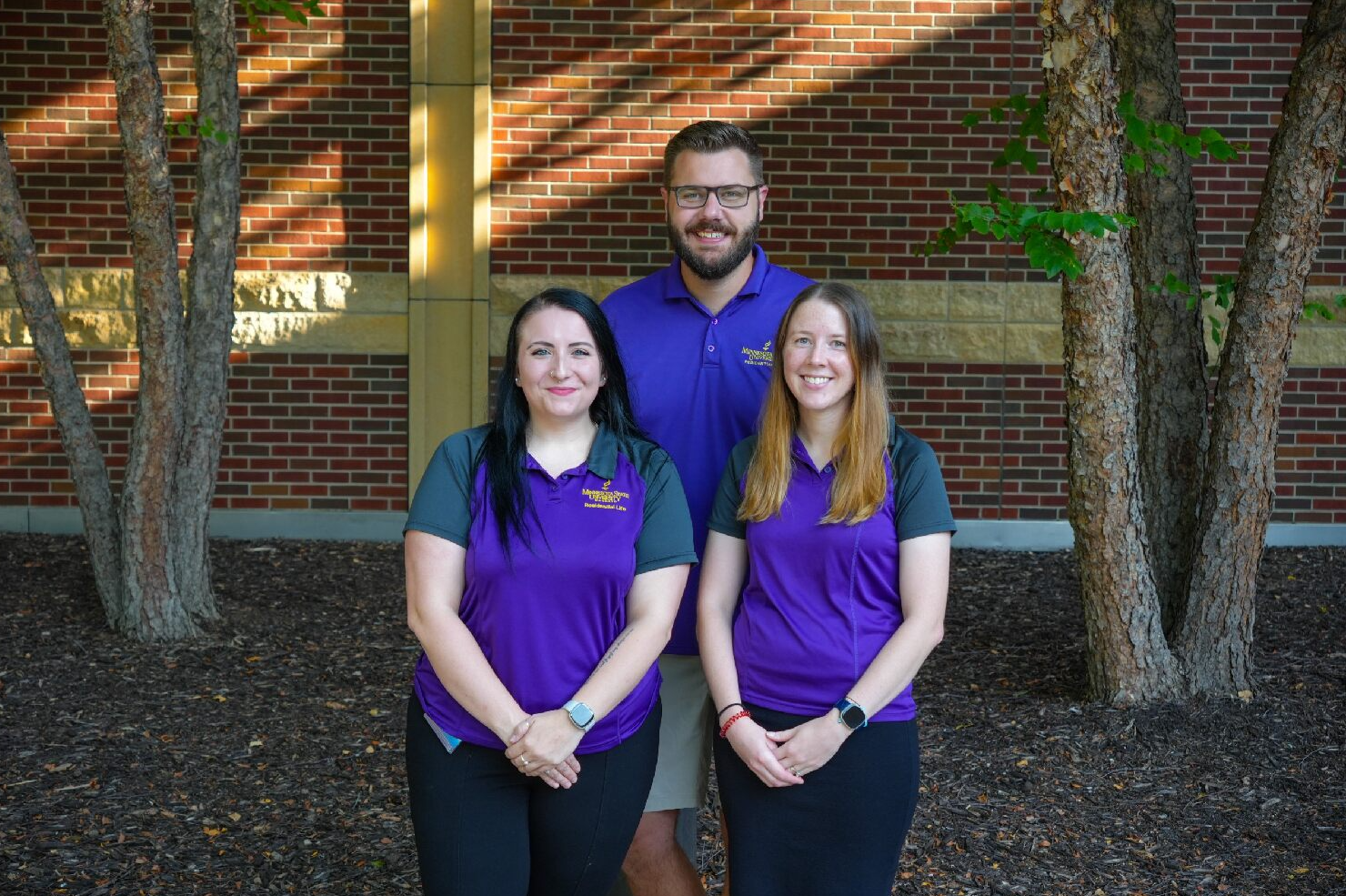 The Residential Education Leadership Team posing outside on the steps