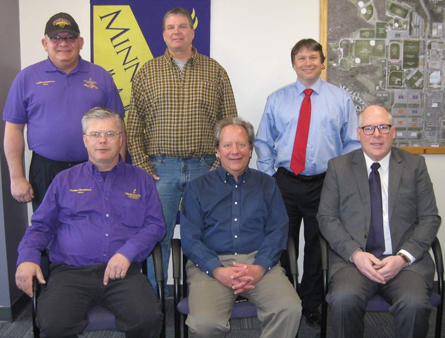 a group of men posing for a photo